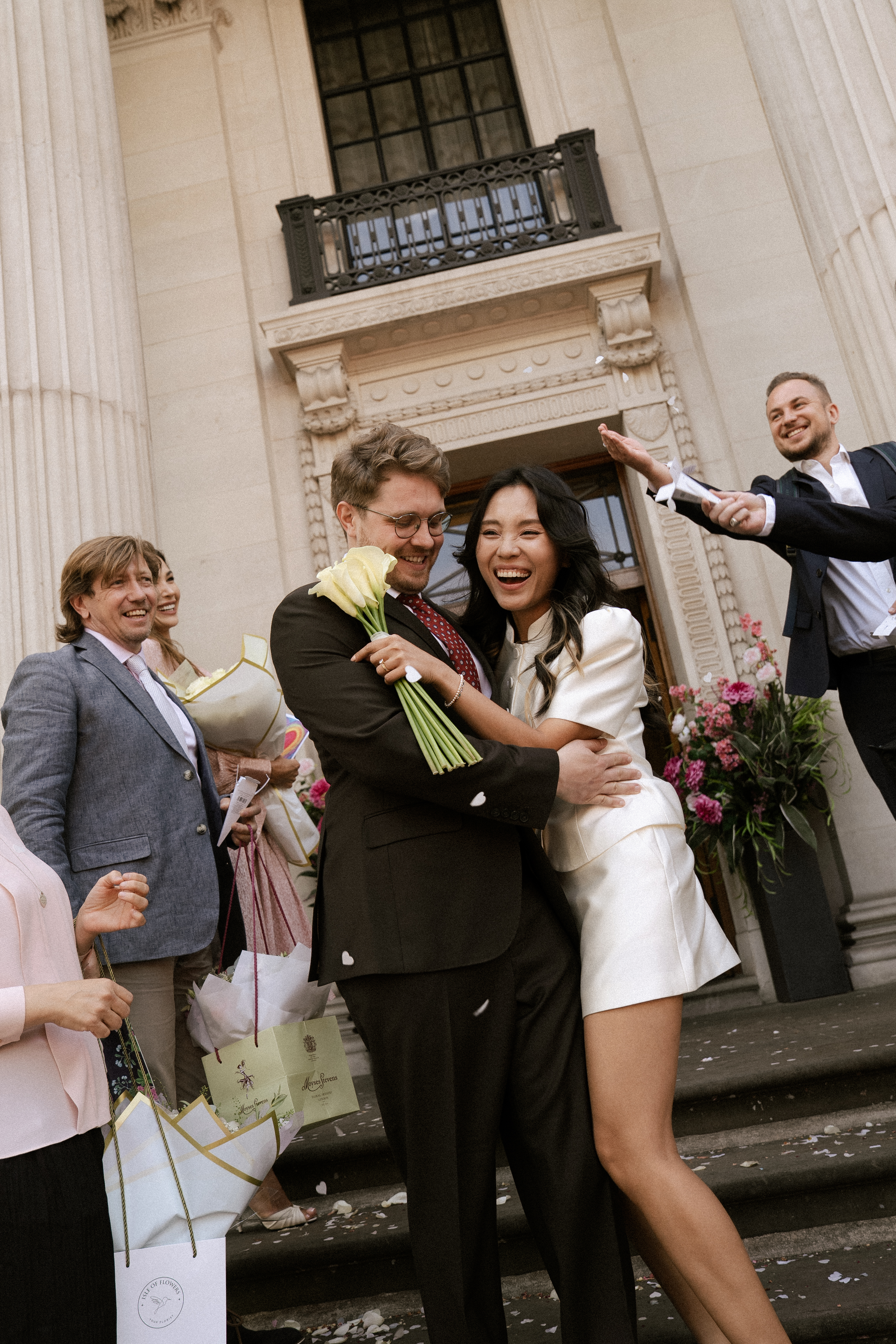 Anh and Mikhail embracing and smiling on their wedding day
